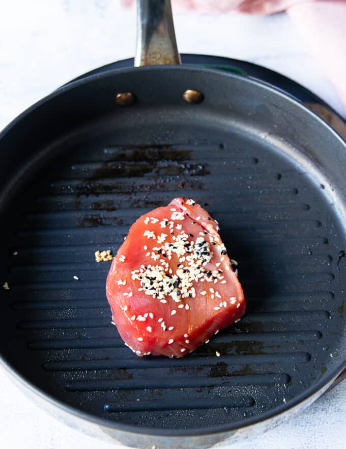 ahi tuna placed on a grill pan to sear 