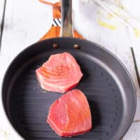 Tuna steaks in a grill pan cooking